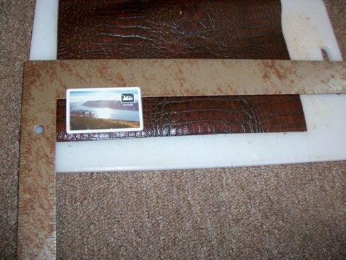 Measuring cowhide for cutting of leather wallet . 