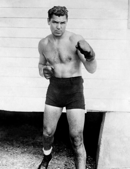 Jack Dempsey in black and white illustration with boxing gloves.